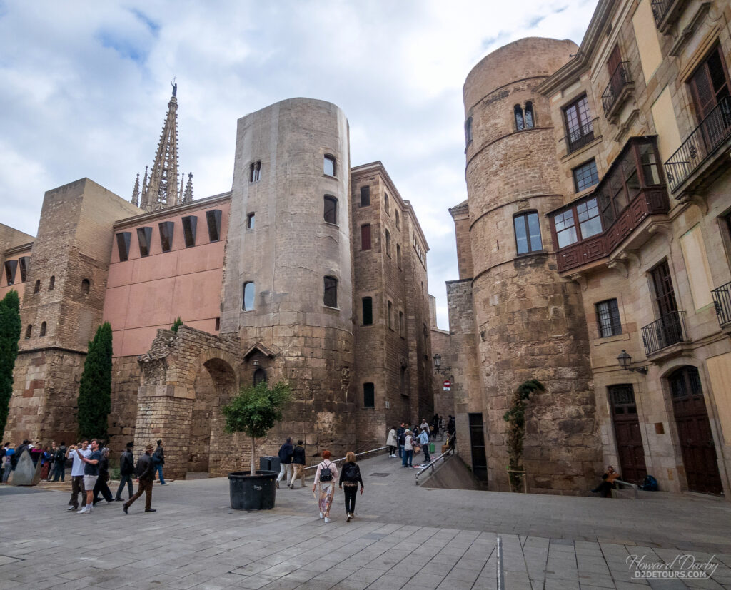 The remains of an old Roman aqueduct and tower incorporated into more modern buildings