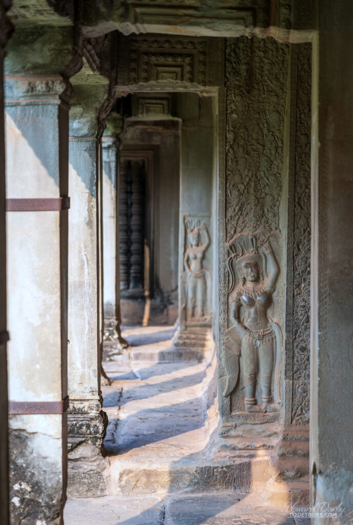 Two of the 1,796 apsaras and devatas carved throughout Angkor Wat