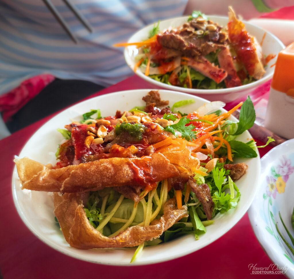 Bún thịt nướng (cold rice vermicelli topped with grated vegetables, grilled pork and fish sauce)