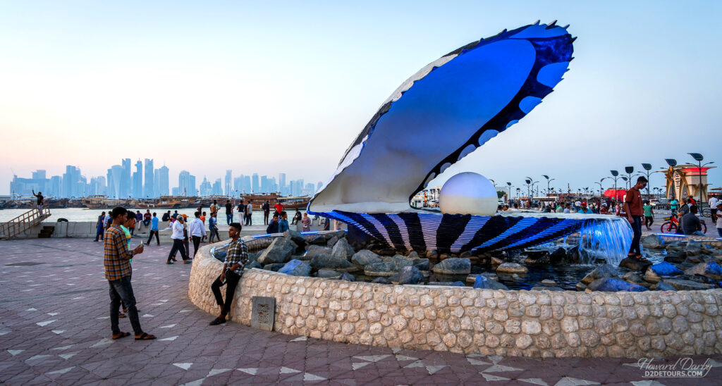 Qatar residents enjoying the evening along the waterfront at The Pearl Monument, a celebration to Qatar's main export prior to oil becoming the main revenue stream.