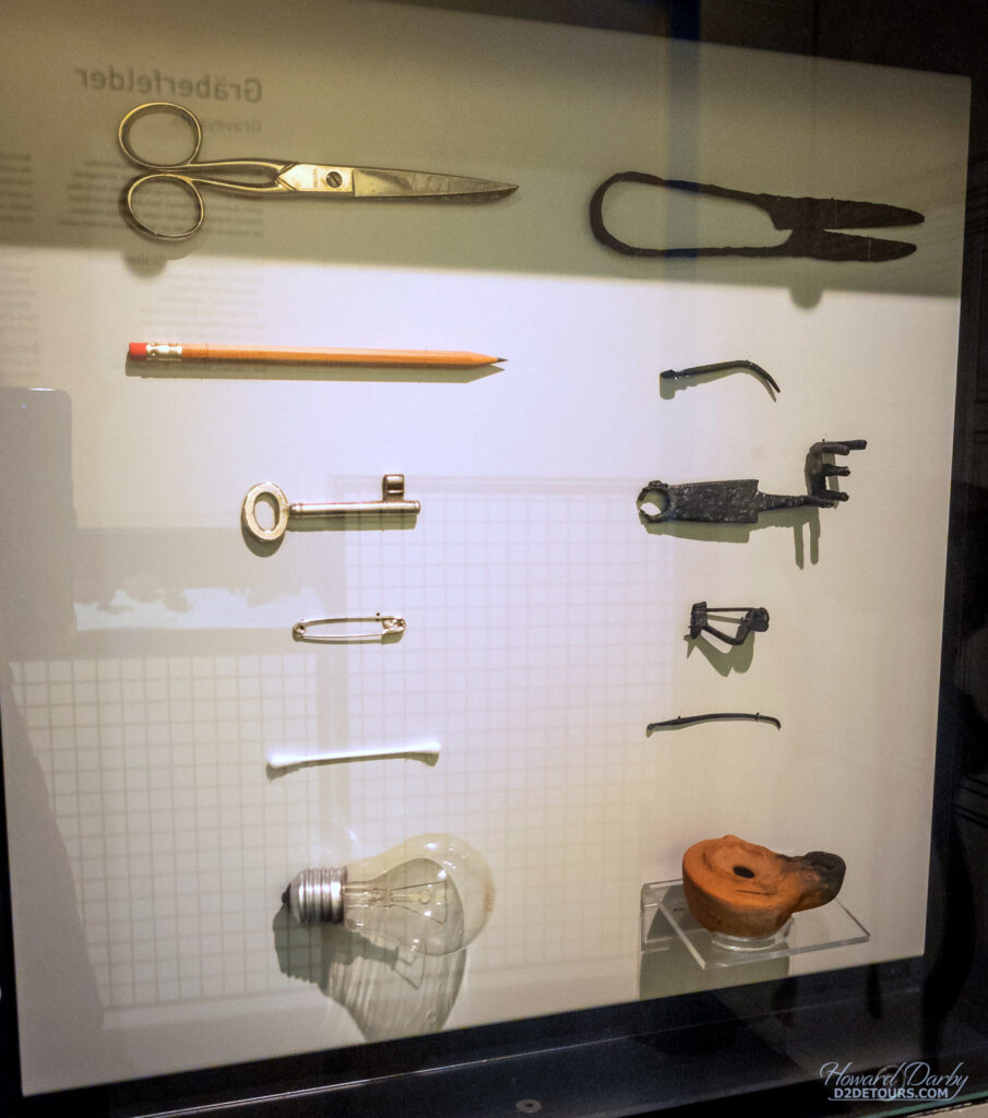 Display showing Roman artifacts found on the site (right side) along with their current counterparts