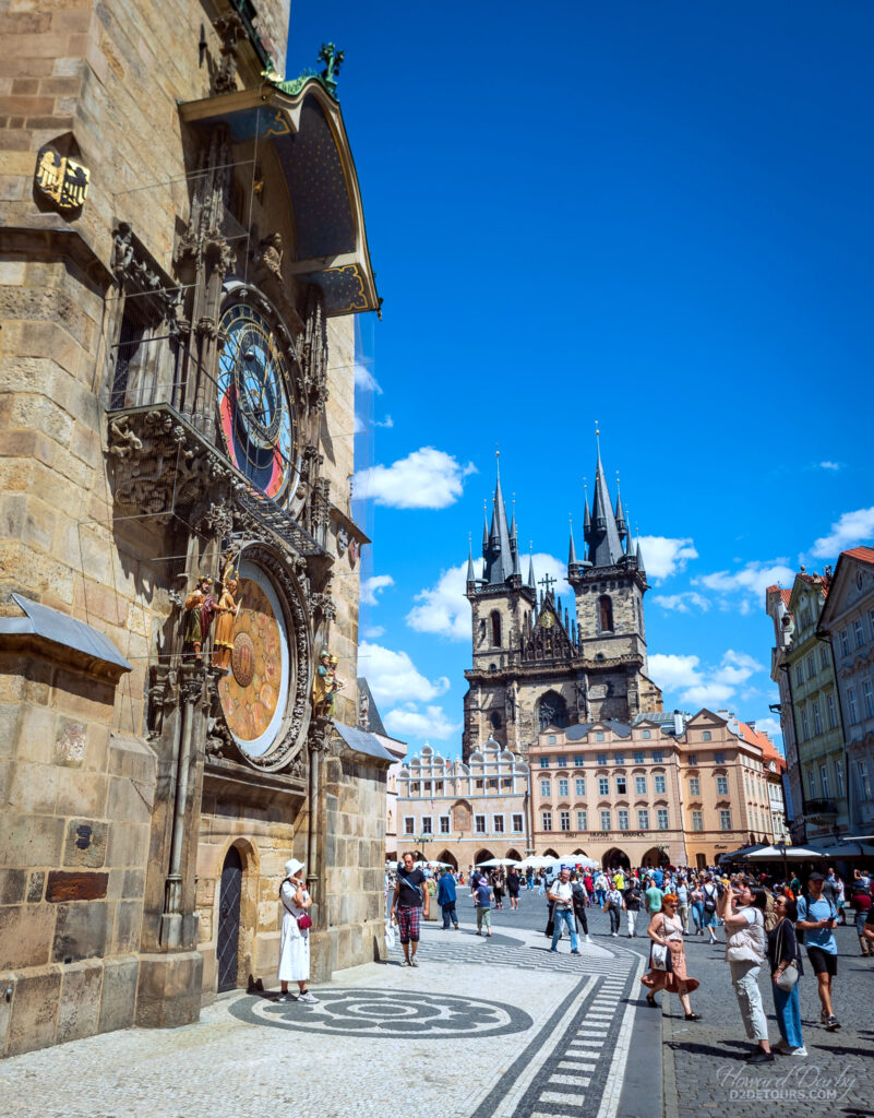 Prague’s Astronomical Clock in the foreground with Church of Our Lady before Týn in the distance