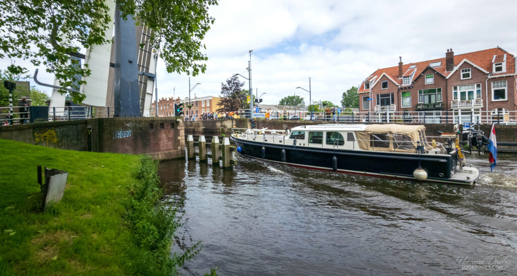 A boat passing under a drawbridge in Delft