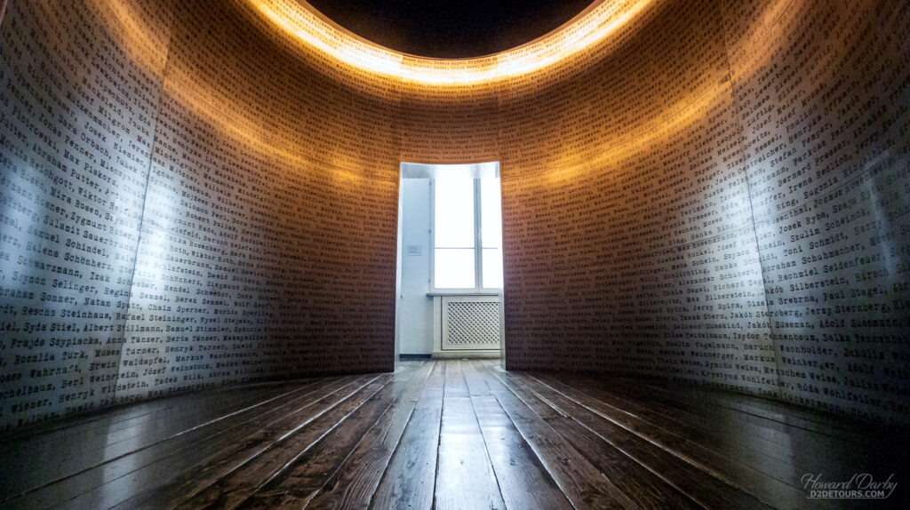 A display within the Schindler building with names of Jews who were victims of the Nazis