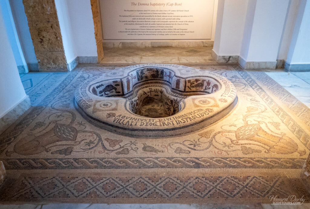 Baptismal font covered in mosaic tiling