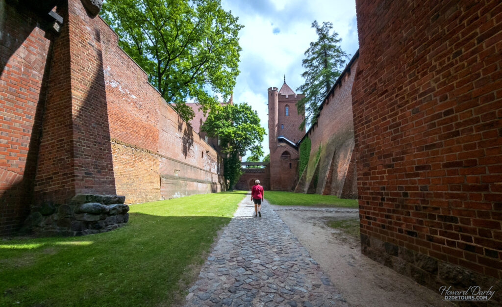 Walking the inner dry moat in Malbork Castle